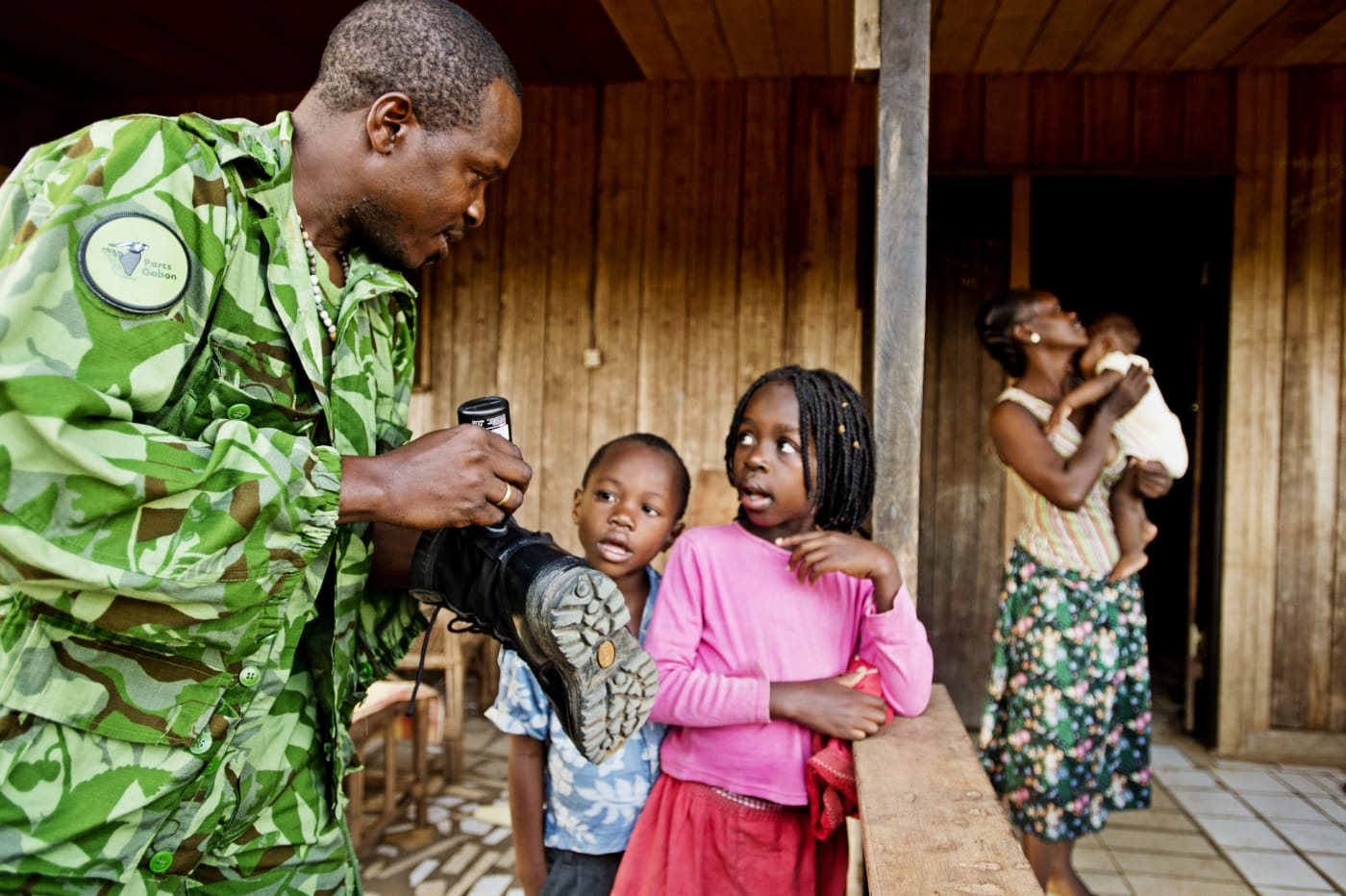 Parcs Gabon eco guard, Soho Jocelyn, makes last minute preparations and says goodbye to his family as he is ready to depart on a two week anti-poaching patrol mission, Makokou, Gabon.