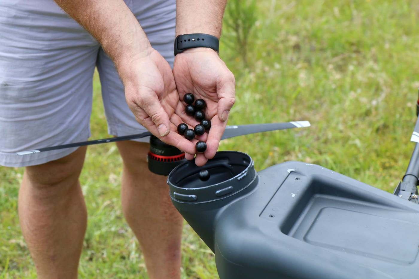 Seed pods being poured into an AirSeed Technologies drone