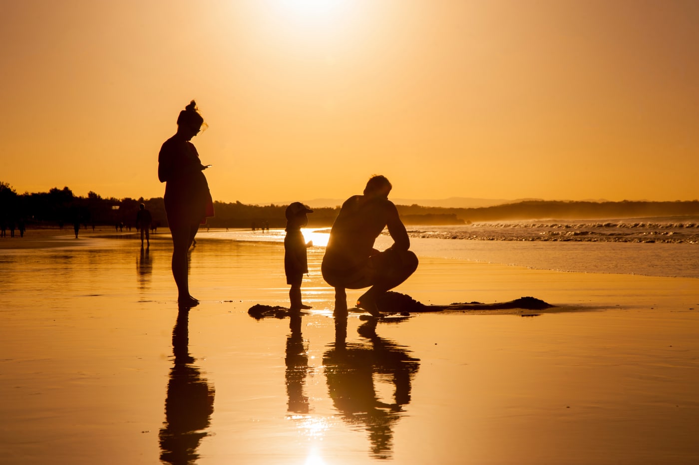 Family at sunset on the beach in Noosa, Queensland.