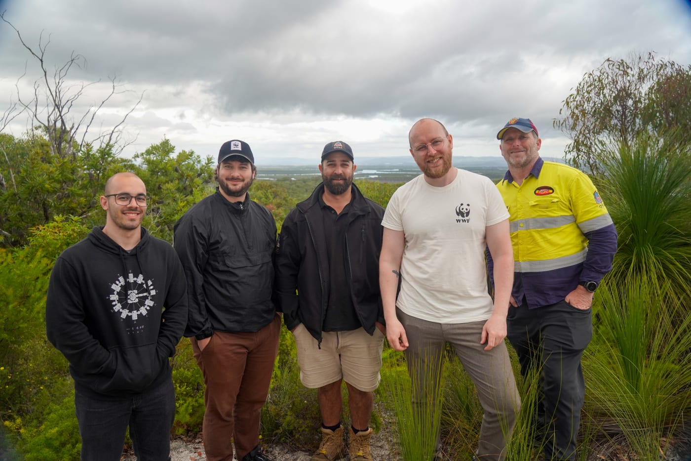 (L-R) Robotto's Lucas de Paula, WWF-Australia's Djarra Delaney, QYAC's Ryan Kucirek, Robotto's Kenneth Geipel and QYAC's Dan Carter on Minjerribah (North Stradbroke Island)