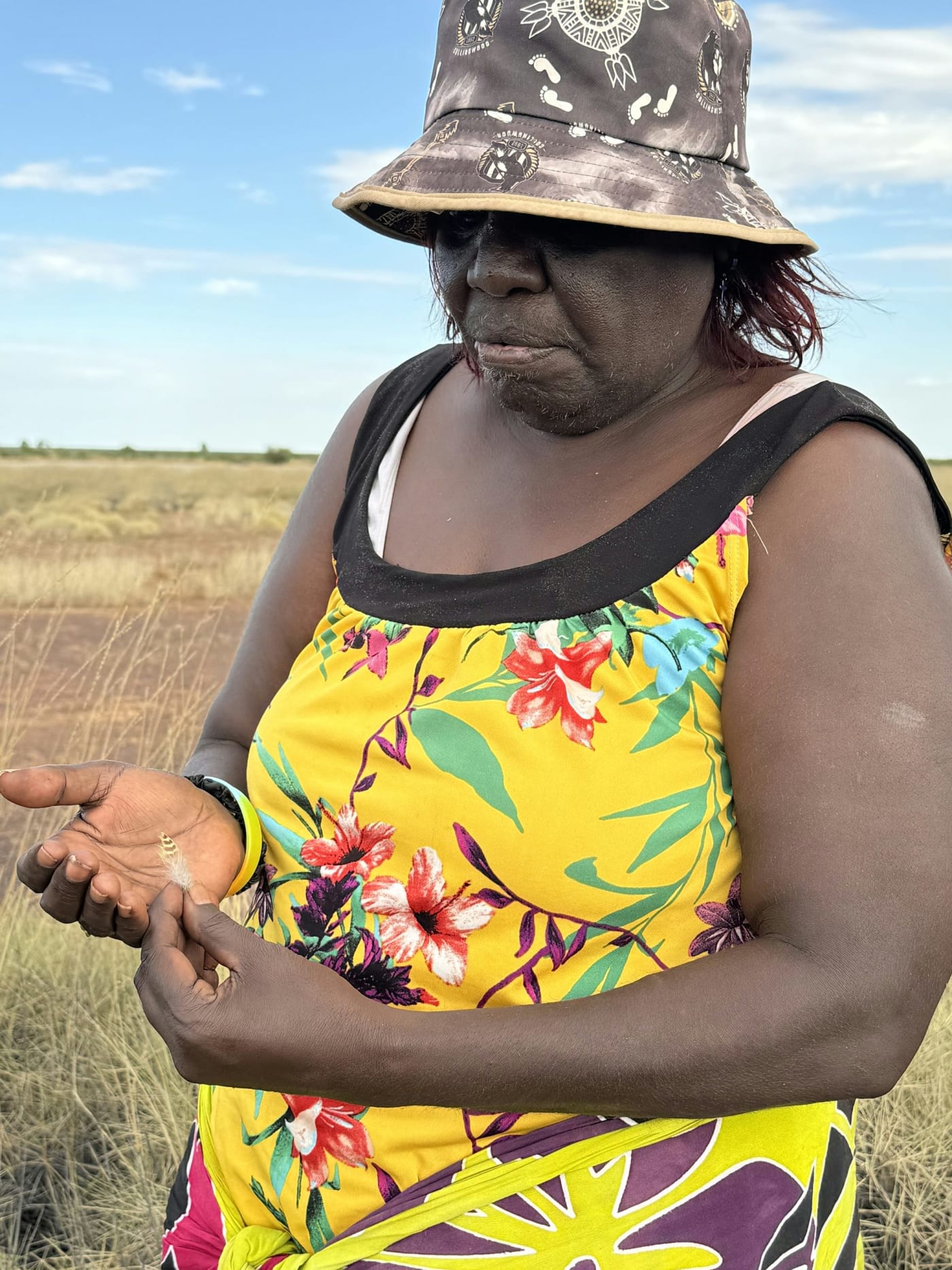 Ngururrpa Ranger Kathryn Njamme with a night parrot feather.