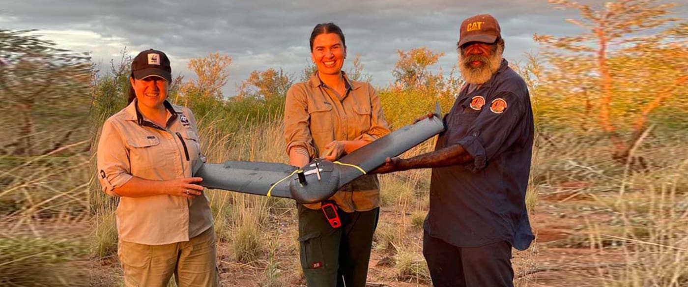 Pictured (left to right): Leigh-Ann Woolley (Species Conservation Manager WA, WWF-Australia), Aliesha Hvala (Drone Pilot, Charles Darwin University), William Watson (Nyikina Mangala Ranger, Walalakoo Aboriginal Corporation) holding the fixed-wing drone used for wiliji surveys on Nyikina Mangala Country