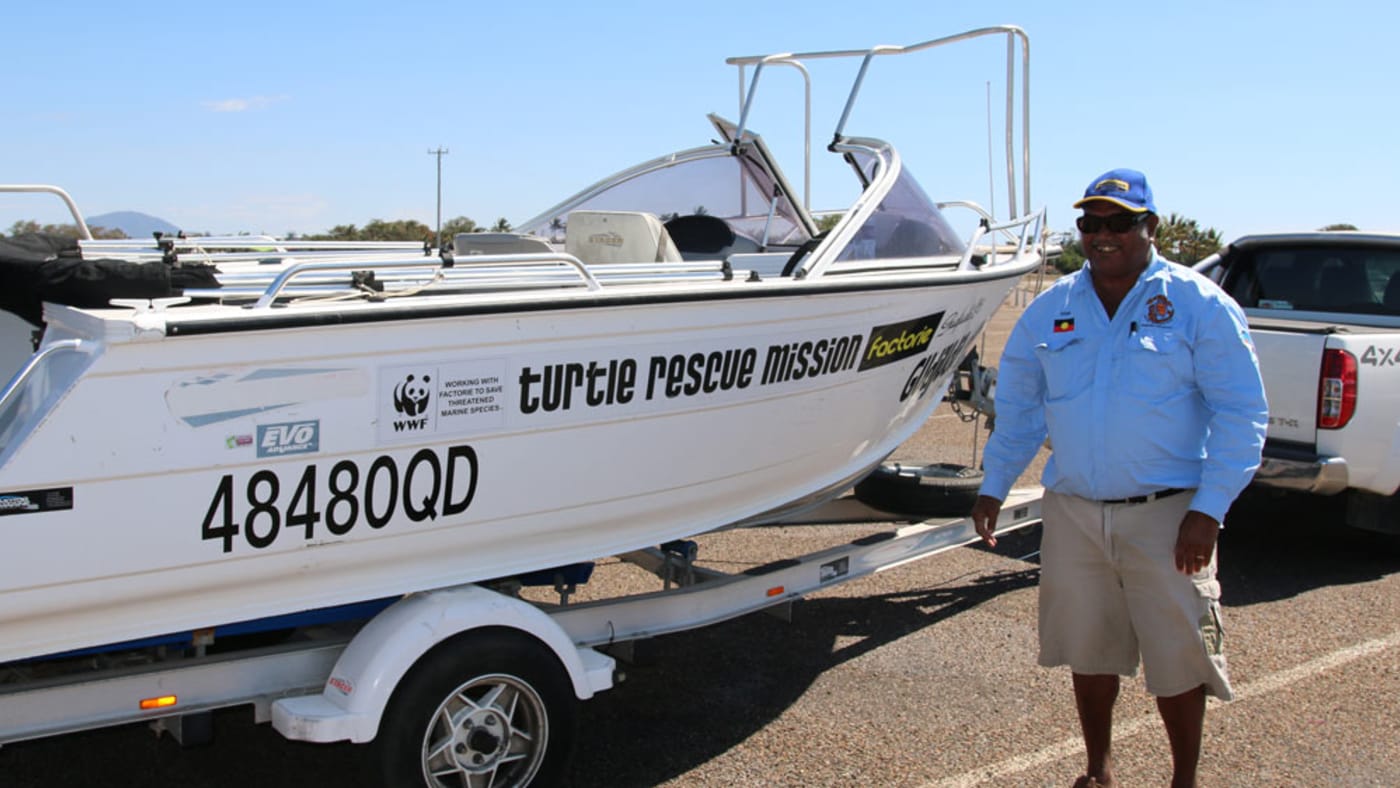 Uncle Eddie next to the boat used to find and tag turtles