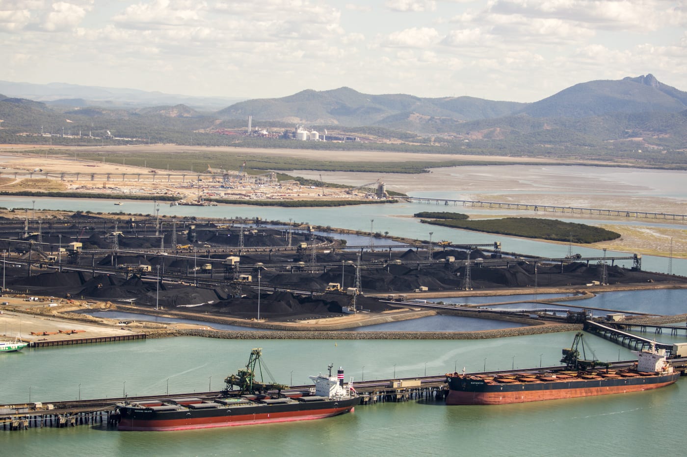 Large export vessels are loaded with coal and other cargo at the Gladstone Port. Queensland, Australia.