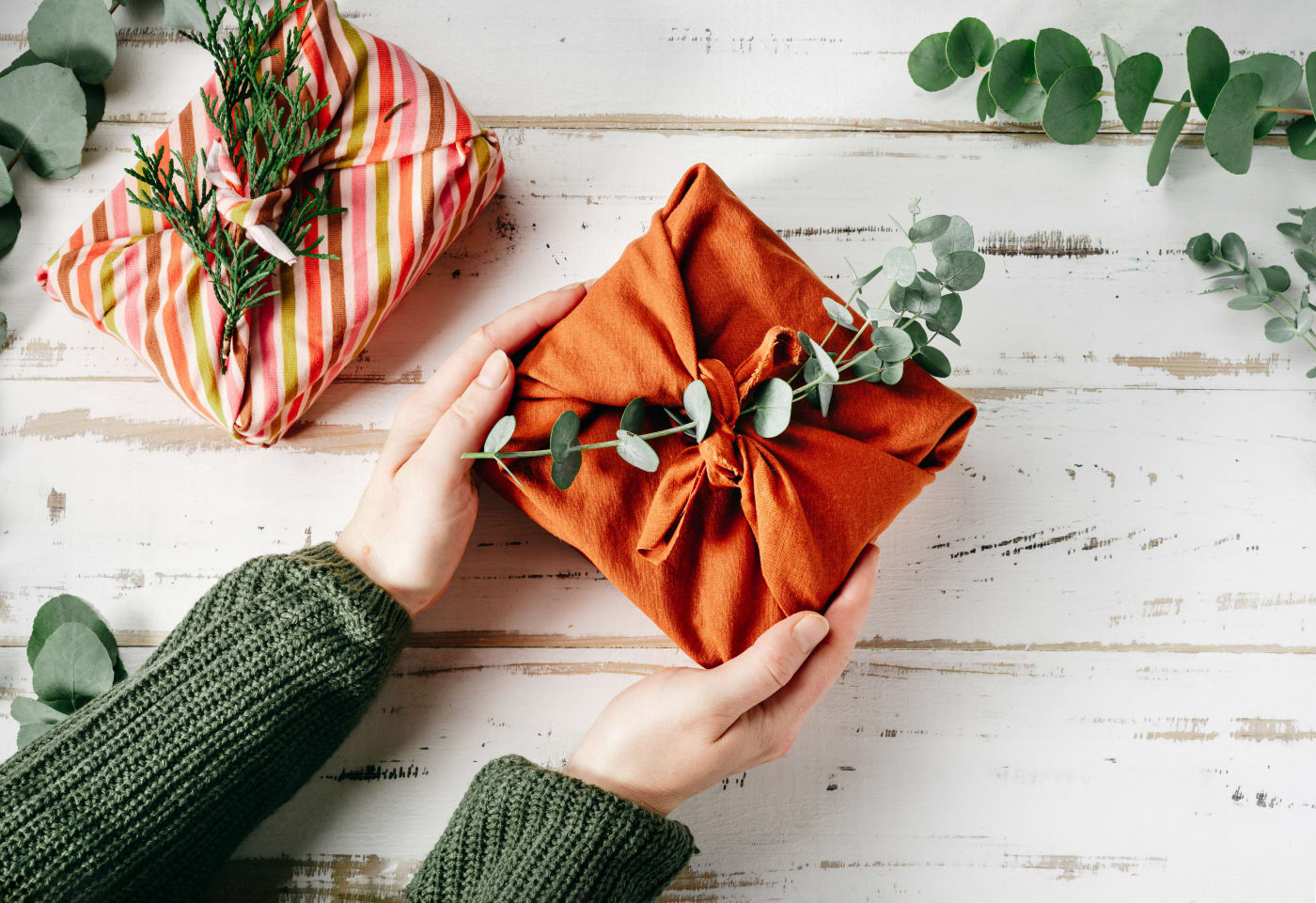 Cloth-wrapped gift with eucalyptus leaves