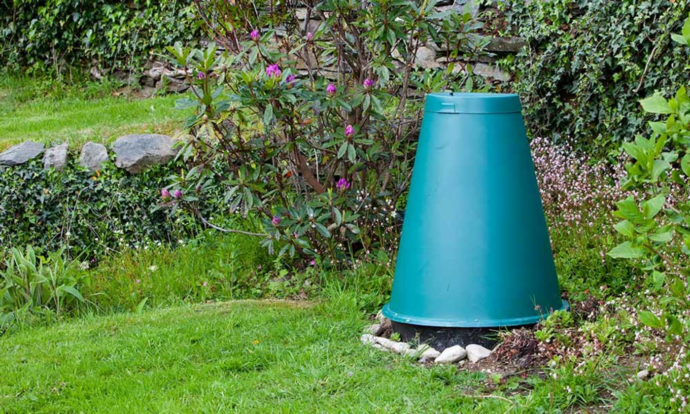 A cone food waste digester is seen in a garden (compost)