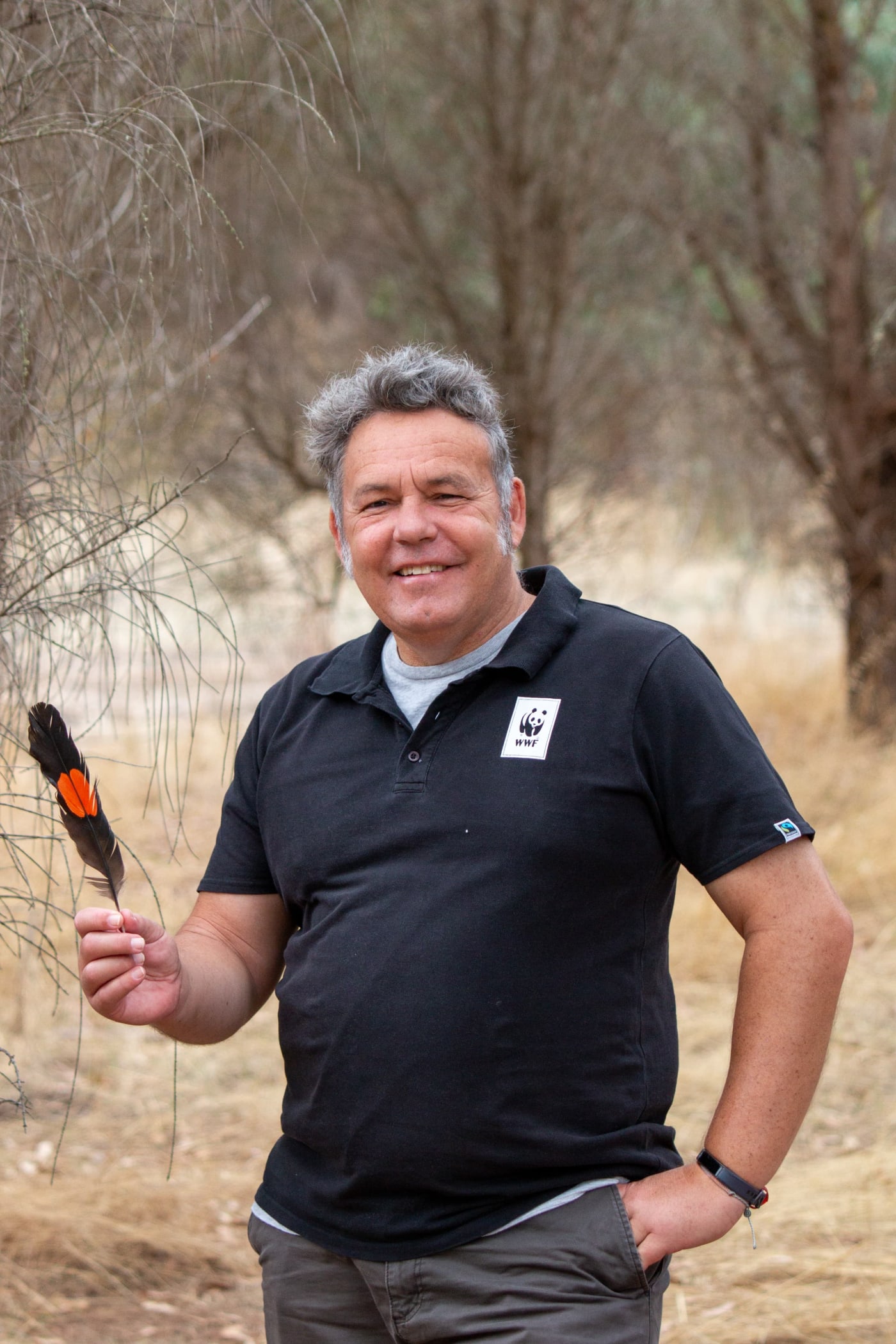 Darren Grover with a glossy black cockatoo feather he found on Kangaroo Island