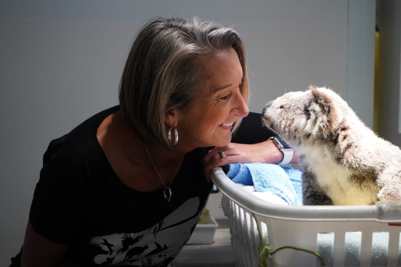 Layne Beachley with a koala in care at Port Stephens Koala Sanctuary