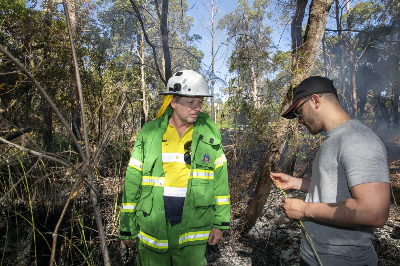QYAC's Dan Carter and Lucas de Paula from Robotto inspects vegetation post Cultural burn on Minjerribah (North Stradbroke Island)