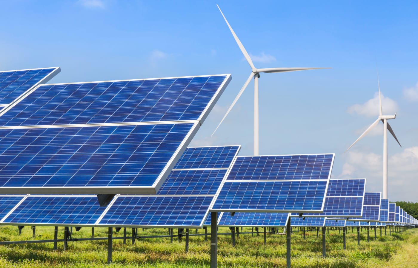 Solar panels and wind turbines generating electricity in solar power station