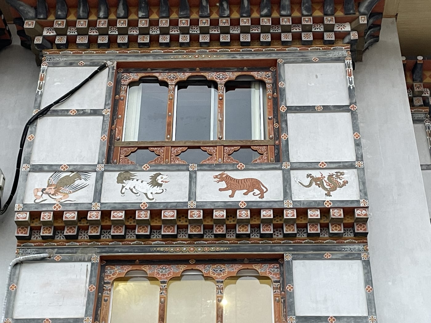 Wall art representing four protective species including the tiger in Bhutan.