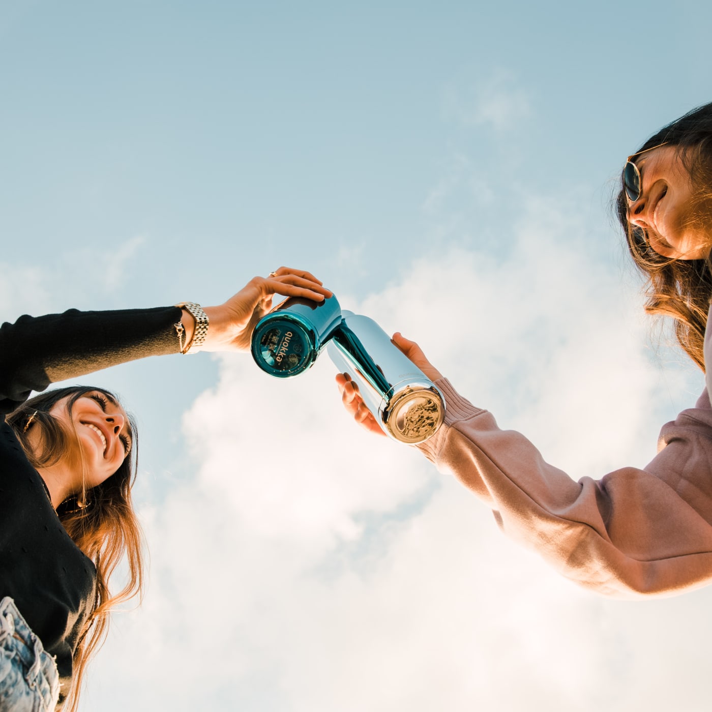 Friends using reusable water bottles