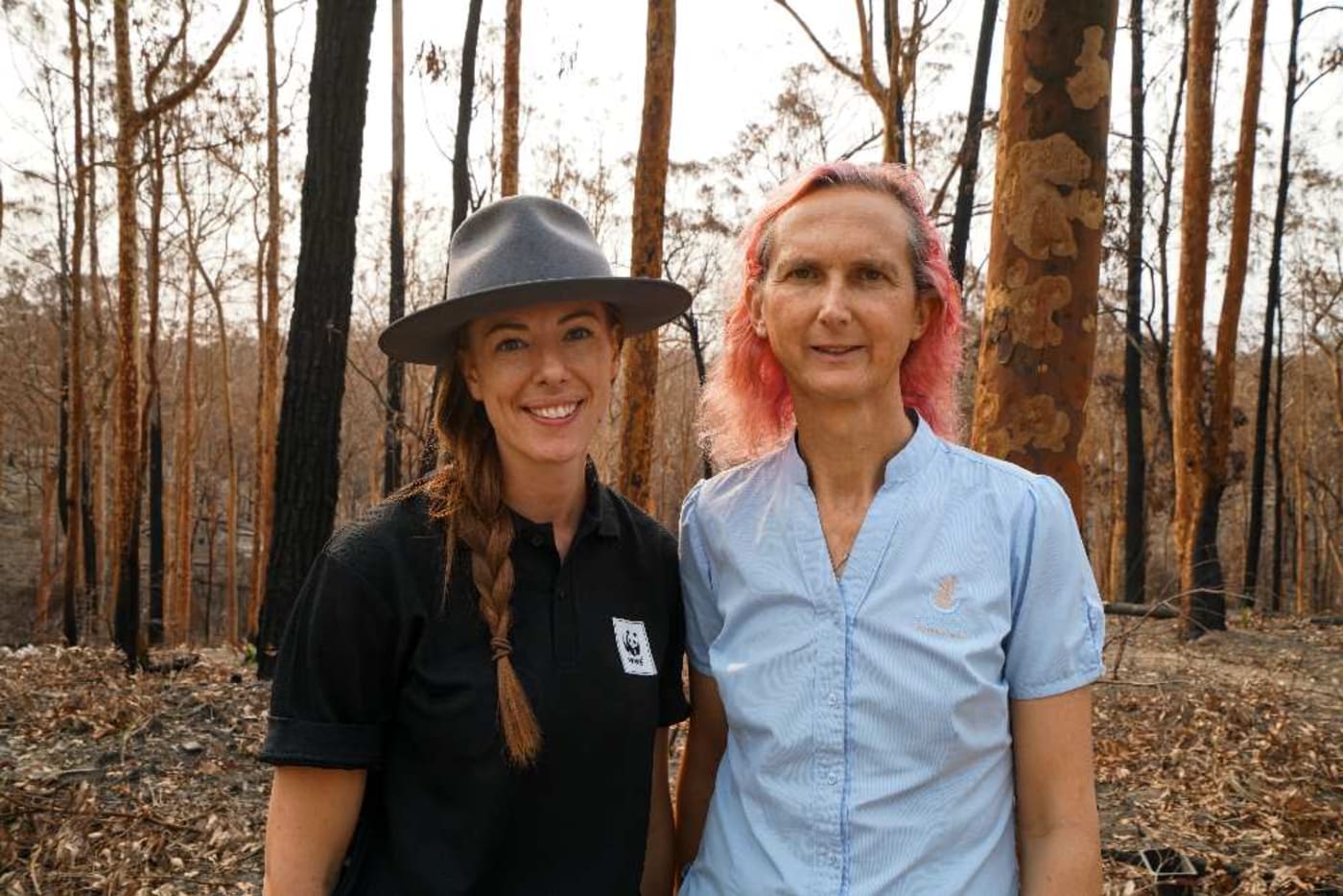 Abigail Sexton and Dr Kate Toyer standing in burnt-out bushland