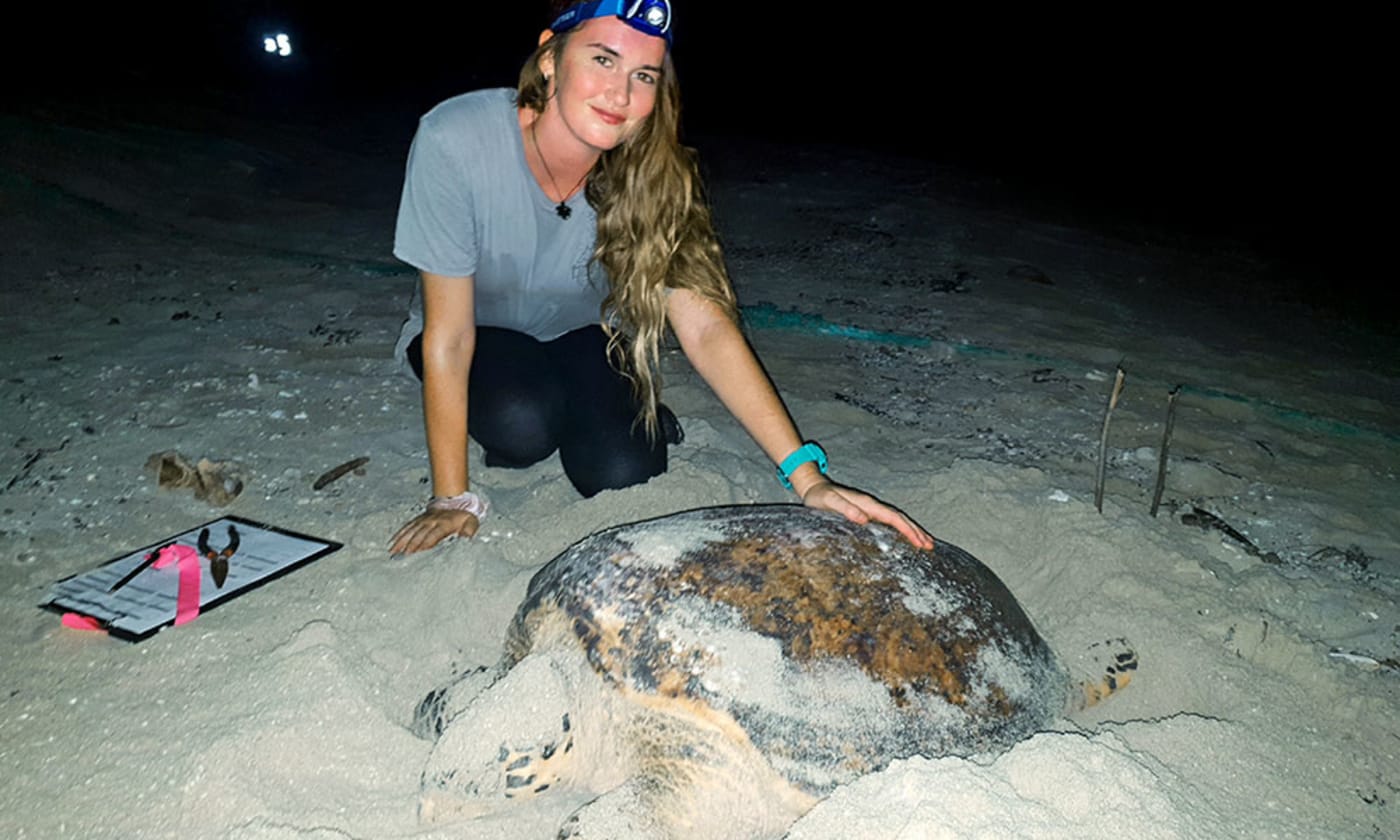 Melissa Stains with a hawksbill turtle on Milman island