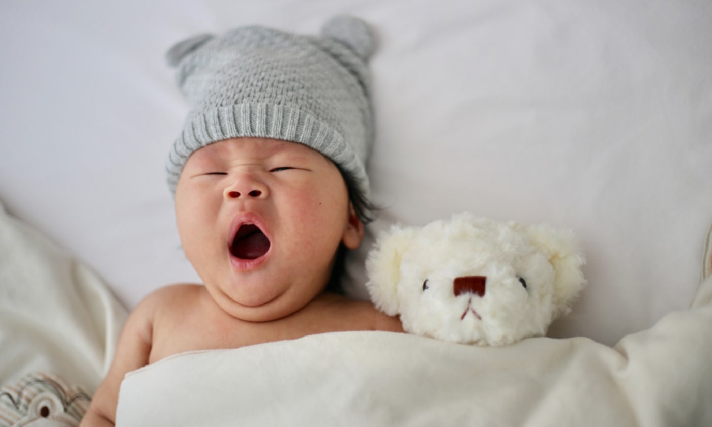 Newborn baby yawning. Photo by Minnie Zhou on Unsplash