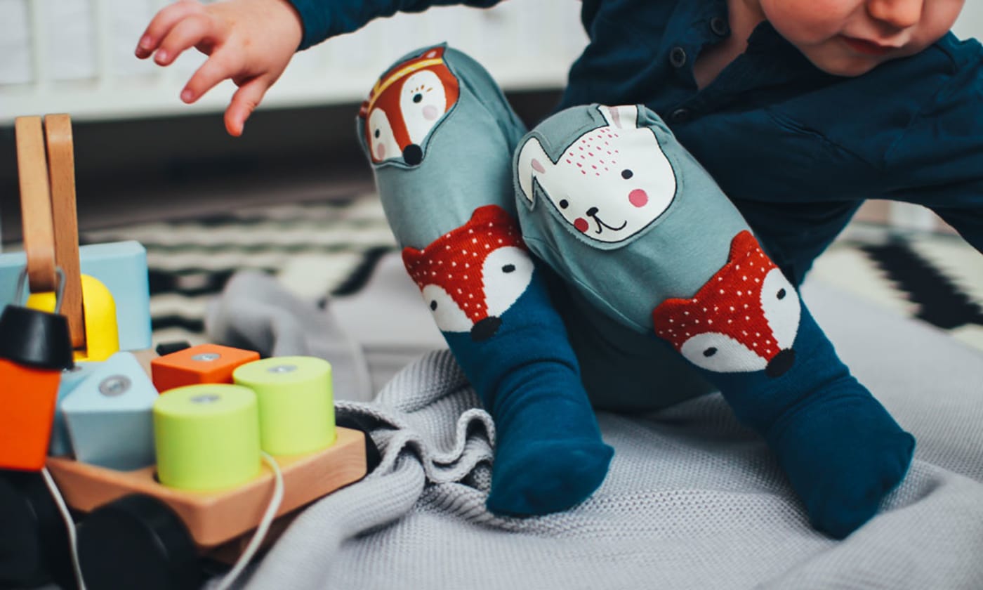 Baby playing with wooden toys. Photo by Daiga Ellaby on Unsplash