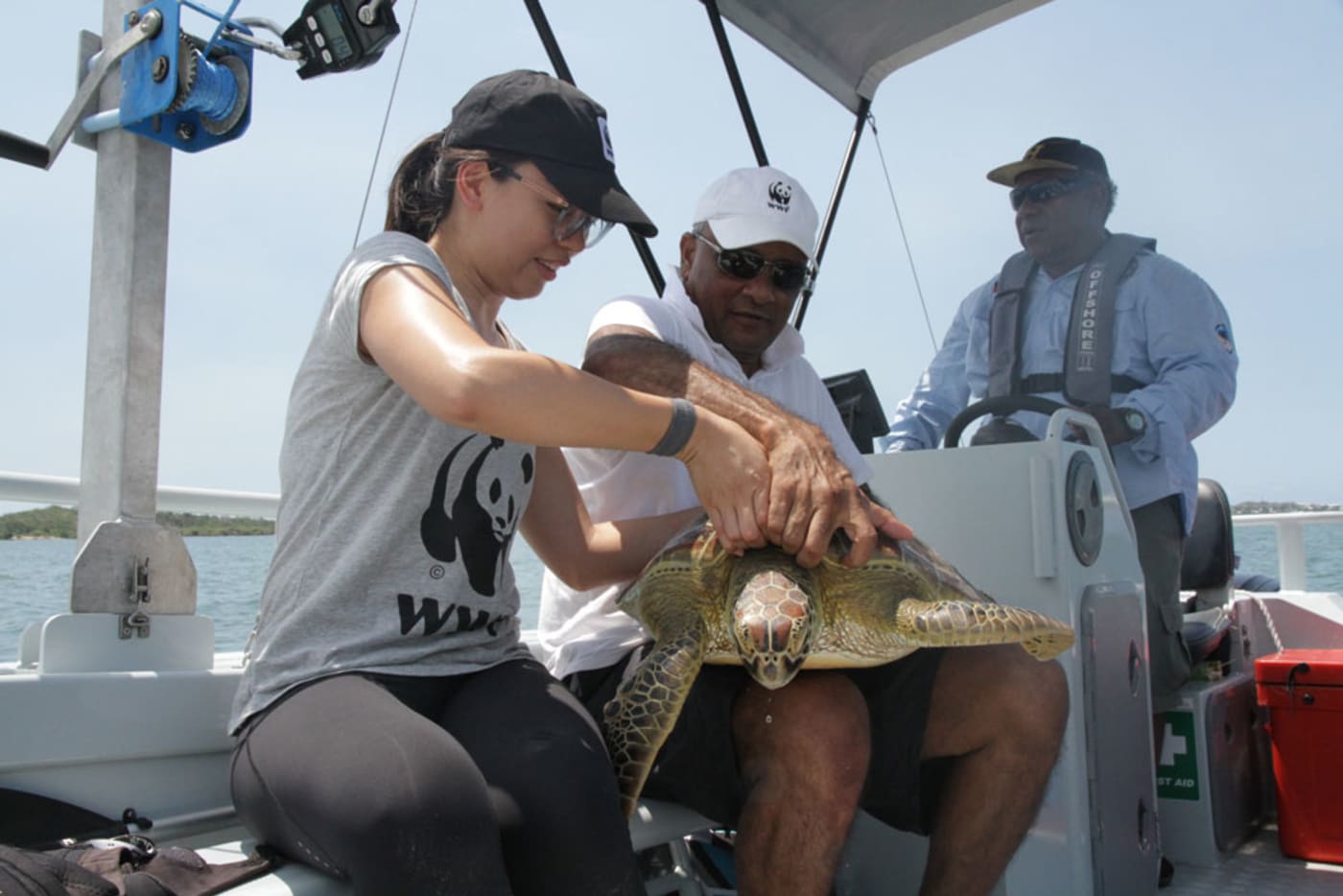 Content Producer, Leonie Sii and National Conservation on Country Manager, Cliff Cobbo with a green sea turtle
