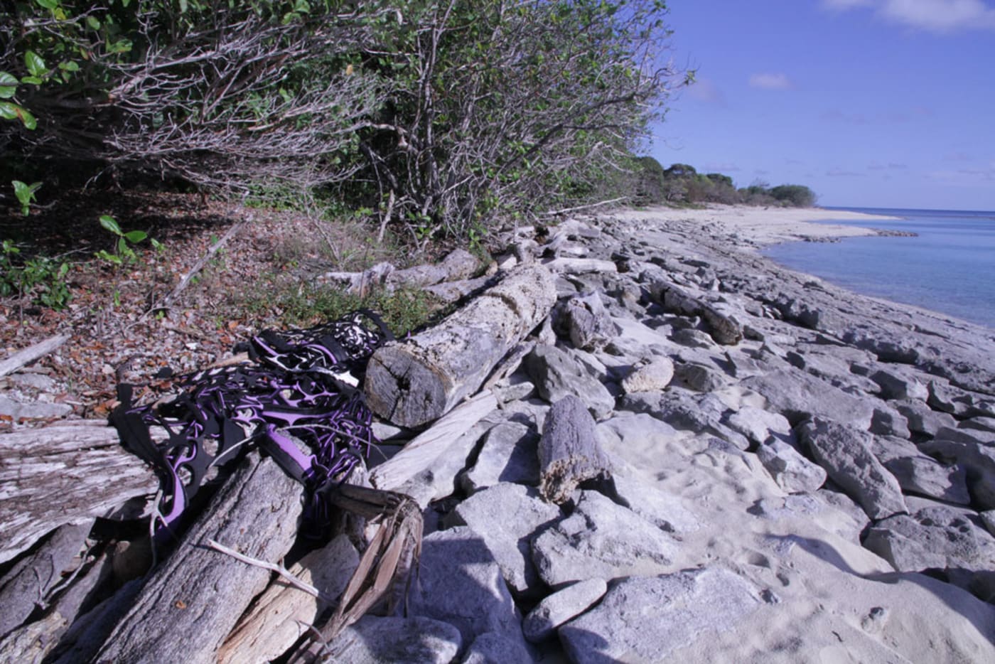 Industrial piece of rubber wedged under rocks on Milman Island