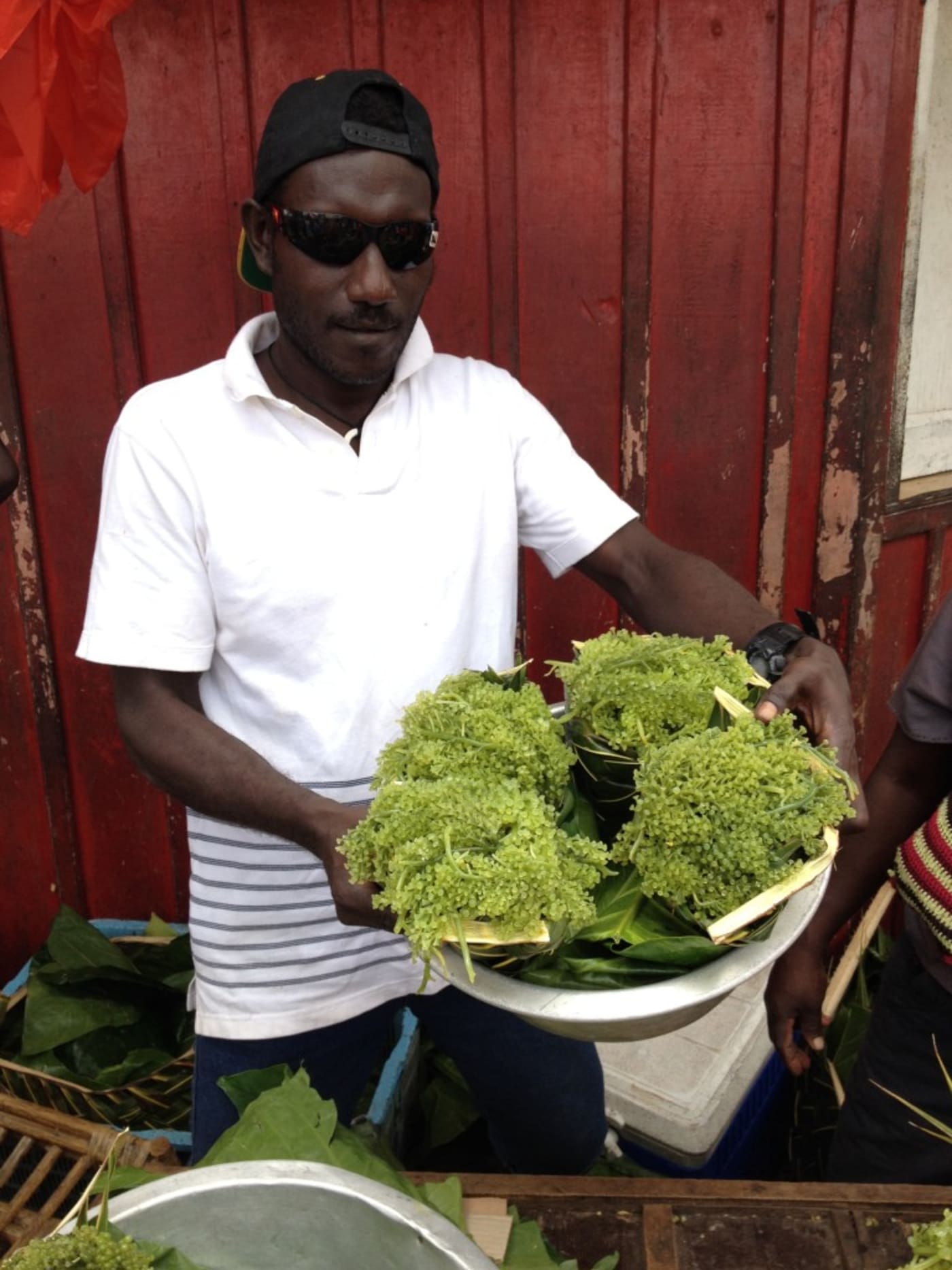 Alpha Ghelly holding seagrapes= Solomon Islands