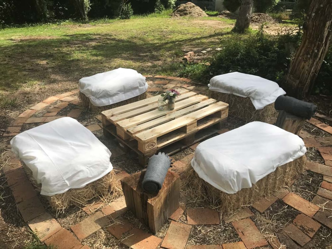Bales of hay and recycled wooden pallet turned into wedding furniture