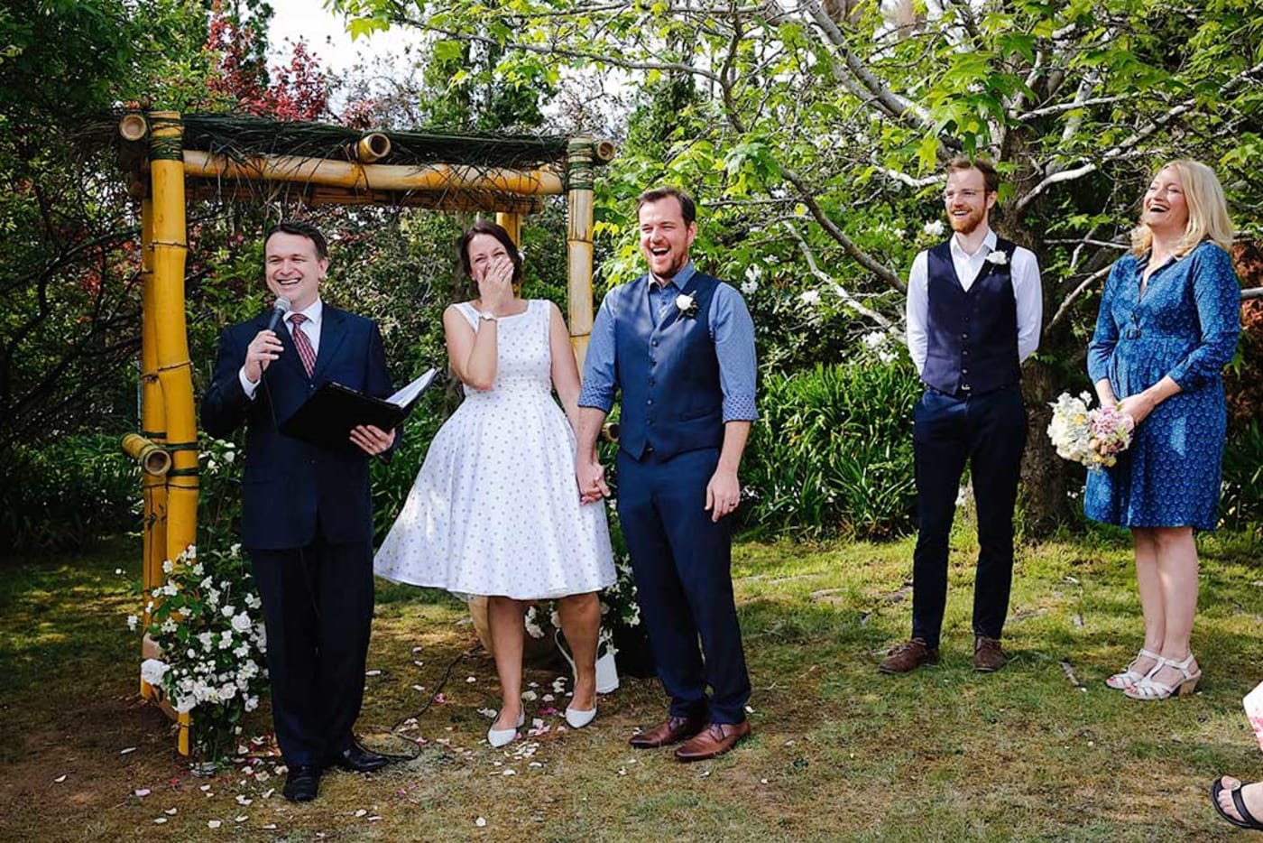Nat & Reece under their sustainable wedding arch made from bamboo