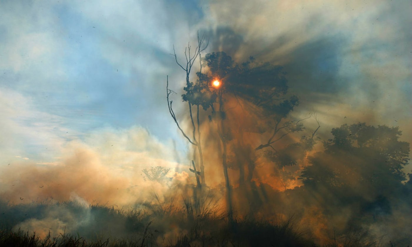 Smoke rising from a fire in the Amazon= Brazil