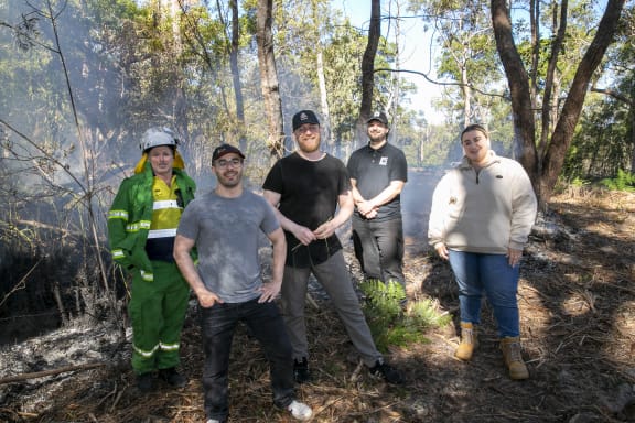 (L-R) QYAC's Dan Carter, Robotto's Lucas de Paula and Kenneth Geipel, WWF-Australia's Djarra Delaney and QYAC's Kiah Morgan at a cultural burn at Flinders Beach, Minjerribah (North Stradbroke Island)
