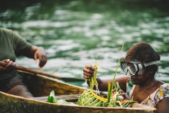 Elma, a community member harvesting sea grapes.