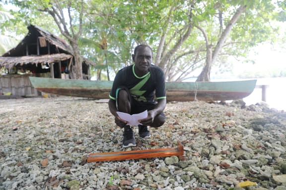 Sese is a local fisherman collecting Spawning Potential Survey (SPS) data using the board WWF helped make for him. By measuring fish against the lengths on the board he is able to help manage the health of the reef for the future.
