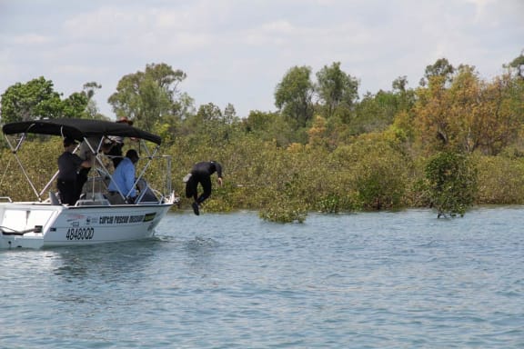 Gudjuda Ranger Aron diving in to catch a green sea turtle in Bowen, Queensland