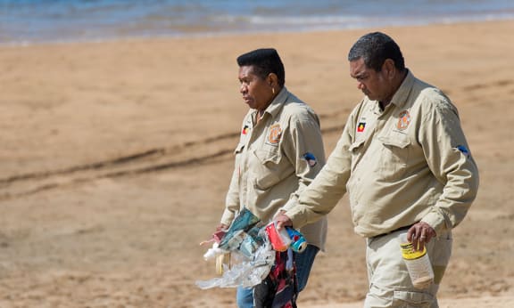 Gudjuda Rangers Dianne Smallwood and Eddie Smallwood collecting floatsom at Alva Beach= North Queensland