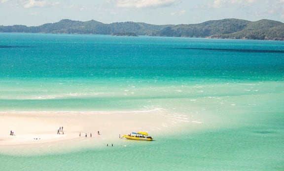 Tourists on Whitehaven Beach in the Whitsundays. Whitehaven Beach is 99% silica. Queensland= Australia