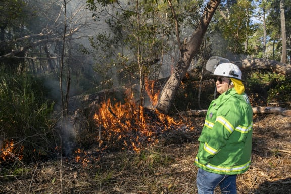 Quandamooka Yoolooburrabee Aboriginal Corporation (QYAC)'s Kiah Morgan at a cultural burn on Minjerribah (North Stradbroke Island)