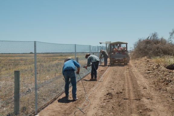 Contractors building the predator control fence on the Yorke Peninsula in South Australia as part of the Great Southern Ark project