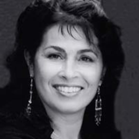 Black and white headshot of woman smiling at camera