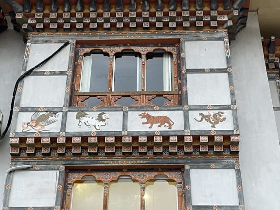 Wall art representing four protective species including the tiger in Bhutan.