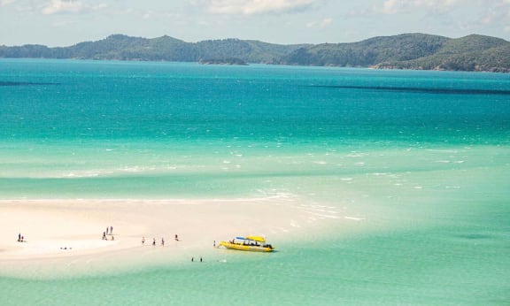 Tourists on Whitehaven Beach in the Whitsundays. Whitehaven Beach is 99% silica. Queensland= Australia