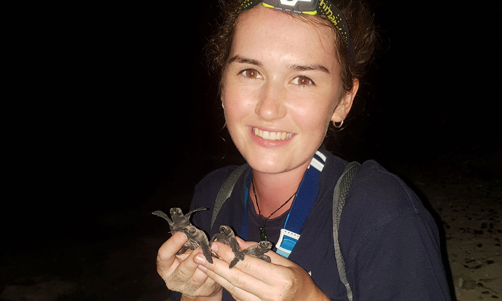 Melissa Staines with turtle hatchlings on Milman Island